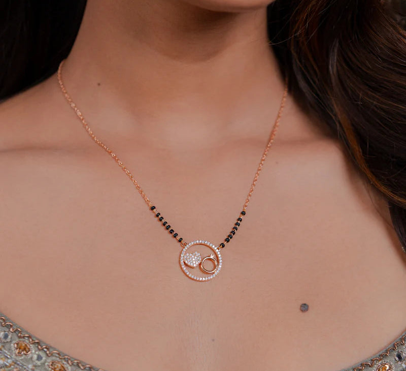 Close-up of a woman wearing a rose gold Mangalsutra.